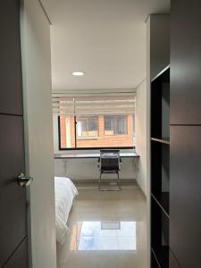 a room with a window and a bed and a desk at Seganis casa hotel in Bogotá +3 photos