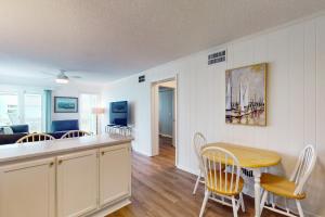 a kitchen and living room with a table and chairs at Seaspray 242 in Atlantic Beach