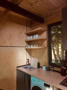 a kitchen with a sink and a counter with a window at Bakhmaro Green Horizon in Bakhmaro +4 photos