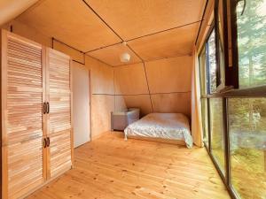 a bedroom in a tiny house with a bed at Bakhmaro Green Horizon in Bakhmaro
