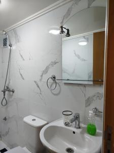 a bathroom with a sink and a mirror and a toilet at Le Refuge de Vittel 2 in Ifrane
