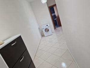 a laundry room with a washer and a washing machine at DURRES SEA SIDE Big Family Apartament in Durrës