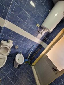 a bathroom with two toilets and a sink at DURRES SEA SIDE Big Family Apartament in Durrës
