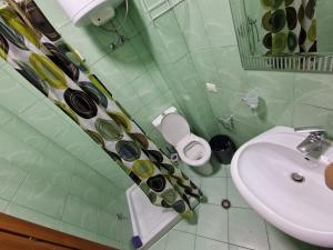 a bathroom with a sink and a toilet at DURRES SEA SIDE Big Family Apartament in Durrës +22 photos