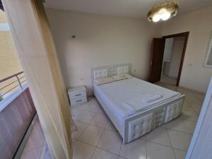 a bedroom with a white bed in a room at DURRES SEA SIDE Big Family Apartament in Durrës