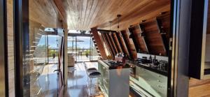 a kitchen with wood paneling and a glass wall at Cabana Sol do Norte in Brumadinho