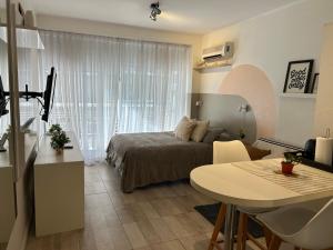 a bedroom with a bed and a table in a room at Monoambiente lujoso en Cañitas! in Buenos Aires