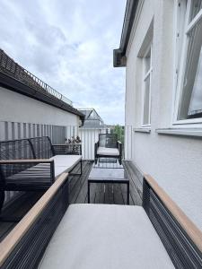 a balcony with benches and tables on a building at designAparts - II - by MorenoPisano in Bayreuth