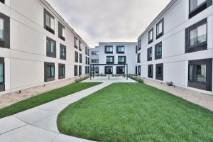 an apartment building with a lawn in the middle at Hampton Inn & Suites San Diego Seaworld in San Diego