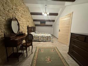 a bedroom with a bed and a vanity and a mirror at Casa Santiago in Ézaro