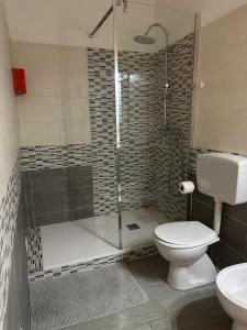 a bathroom with a shower with a toilet and a sink at Affittacamere Gess in Montalto Uffugo