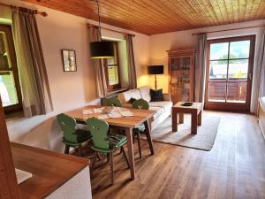 a living room with a table and a couch at Menkenhof in Reit im Winkl