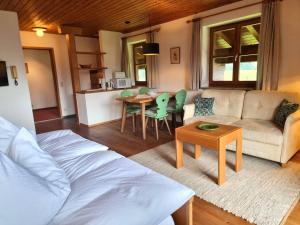 a living room with a couch and a table at Menkenhof in Reit im Winkl +23 photos