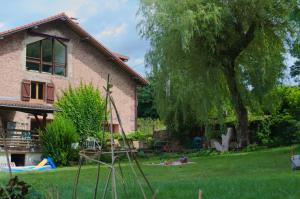 a yard with a house and a tree at Chambre familiale Odile et les cycleux in Docelles