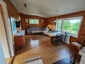 a living room with a couch and a table at Degersandsvägens stugor in Eckerö