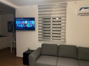 a living room with a couch and a flat screen tv at Equipped studio in Tetouan in Tétouan