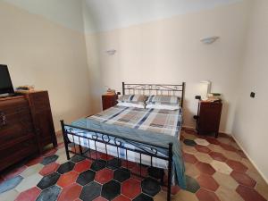 a bedroom with a bed and a dresser and a tv at La casa del tempo in Vittorito