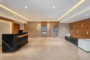 an office with a lobby with wooden walls and a desk at Fairfield by Marriott Jaipur Tonk Road in Jaipur