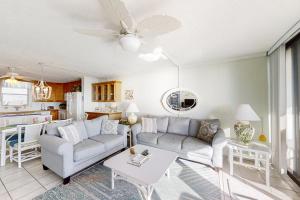 a living room with a couch and a table at Smugglers Cove 508 in Atlantic Beach