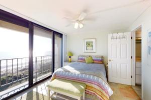 a bedroom with a bed and a balcony at Smugglers Cove 508 in Atlantic Beach +13 photos