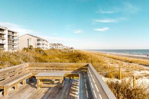 a picnic table on the stairs to the beach at Smugglers Cove 508 in Atlantic Beach