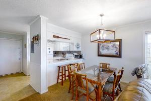 a kitchen and dining room with a table and chairs at A Place At The Beach 271 in Atlantic Beach