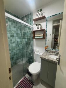 a bathroom with a toilet and a shower and a sink at Hannah House in Marechal Deodoro +17 photos