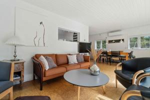 a living room with a couch and a table at Lovely Holiday Home On Bornholm in Neksø
