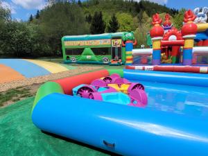 a water park with a water slide and a bus at Penzion Belez in Dolný Kubín