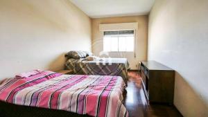 Giường trong phòng chung tại Apartamento aconchegante no centro de itu