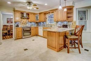a kitchen with wooden cabinets and a table and chairs at Woodland Apartments in Marietta