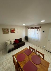 a living room with a table and a couch at Refugio Kooch in Río Gallegos