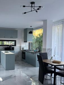 a kitchen with a table and a dining room at Hotel Edelweiss in Ureki