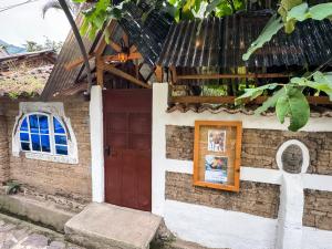 a small house with a door and a window at Unicorn Reborn - Peaceful Rentals in San Marcos La Laguna