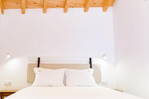 フンダンにあるCasas do Freixial - Casa do Becoの白いベッドと白い枕のある寝室