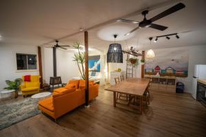 a living room with an orange couch and a table at MP Beach Club in Tootgarook