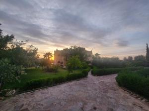 a house in the middle of a garden at sunset at La dolce villa in Aït Bou Zguia