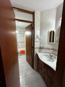 a bathroom with a sink and a mirror at Departamento NILO in San Rafael