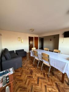 a large room with a table and chairs and a couch at Departamento NILO in San Rafael