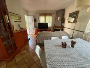 a living room with two tables and a television at La Casa del Bosc, playa y golf - Salou in Salou