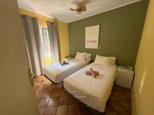 a room with two beds with stuffed animals on them at La Casa del Bosc, playa y golf - Salou in Salou +40 photos