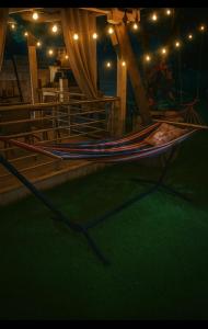 a hammock on a stage with lights in a room at The Garden Apartments in Nea Kalikratia +6 photos
