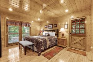 een slaapkamer met een bed, een stoel en een raam bij Knotty Pine Delight Holiday home in Gatlinburg +64 foto's