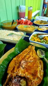 a table topped with a turkey and other dishes of food at Amazon Anavilhanas Lodge in Aiparuça