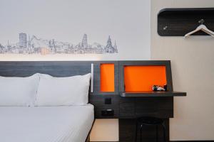 a hotel room with a bed and a tv at easyHotel Zürich City Main Station in Zurich