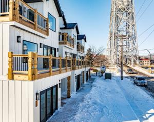 a building with snow on the ground next to a tower at Dragestil 713 Duluth Luxury Condos by Heirloom Boutique Collection in Duluth