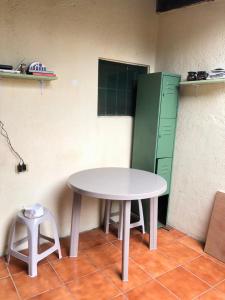 a table and stool in a room with a green cabinet at Hospedaje Económico Antigua in Antigua Guatemala