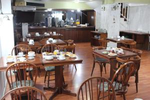 a dining room with wooden tables and chairs at Esmeralda Palace Hotel in Buenos Aires