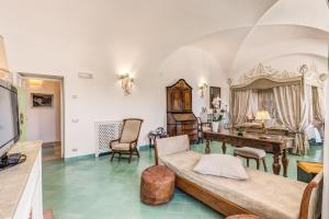 a living room filled with furniture and a large window at Villa Calypso in Capri