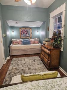 a living room with a couch and a table at Historic Farmhouse - Tranquil Country Nature Escape in Hondo